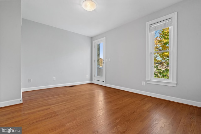 empty room with hardwood / wood-style floors