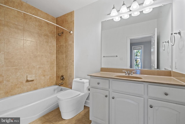 full bathroom with vanity, tiled shower / bath combo, tile patterned floors, and toilet