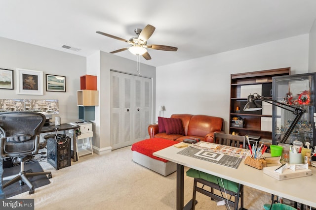 carpeted office with ceiling fan