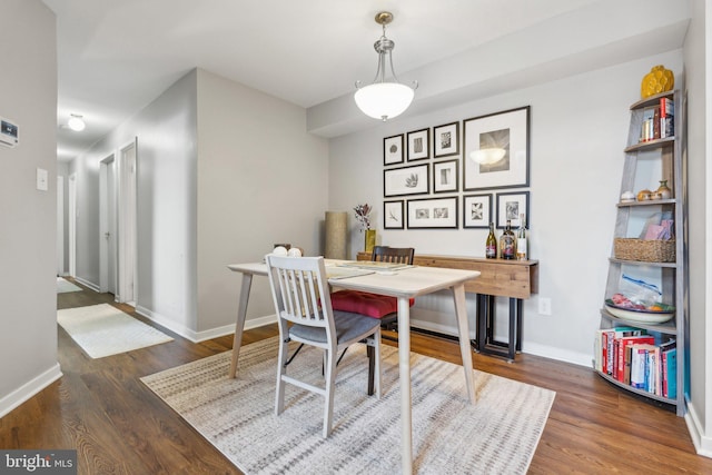 dining area with dark hardwood / wood-style flooring