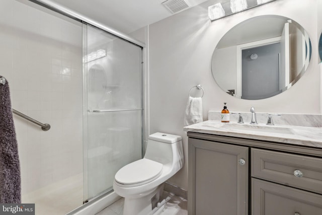 bathroom with vanity, a shower with shower door, and toilet