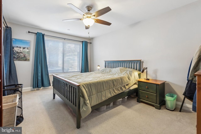 bedroom featuring light colored carpet and ceiling fan