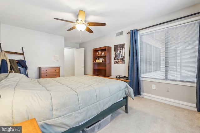 bedroom with ceiling fan and light colored carpet