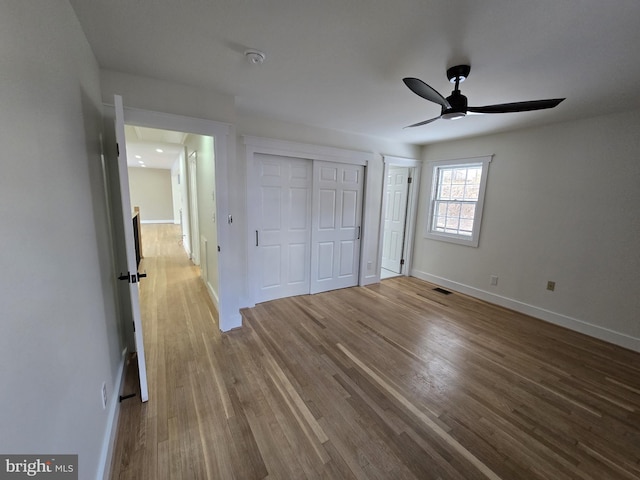 unfurnished bedroom featuring hardwood / wood-style flooring and ceiling fan