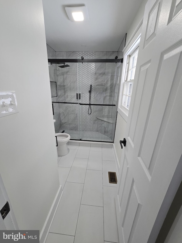 bathroom with walk in shower, tile patterned floors, and toilet