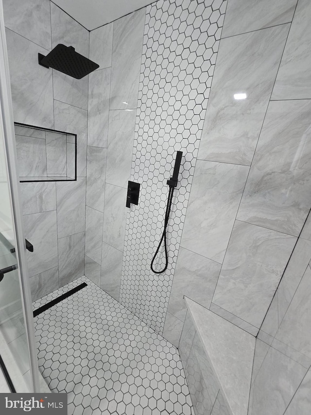 bathroom with a tile shower