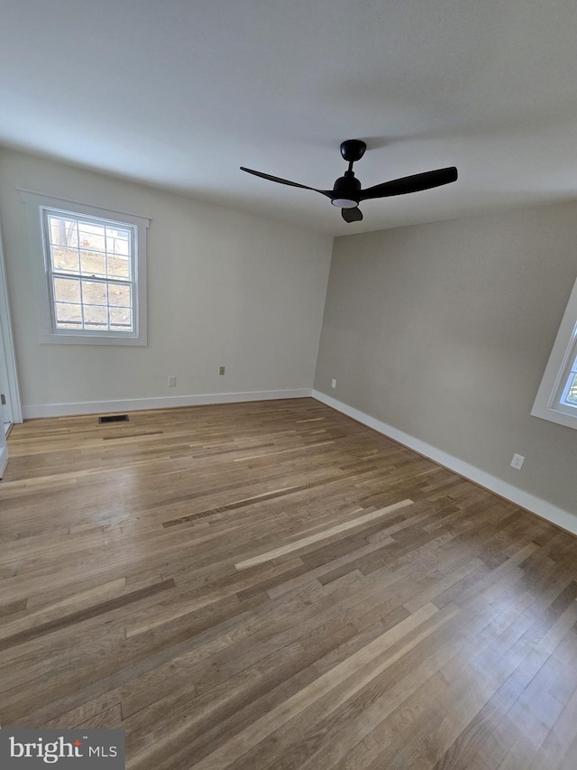 unfurnished room with ceiling fan and light hardwood / wood-style flooring