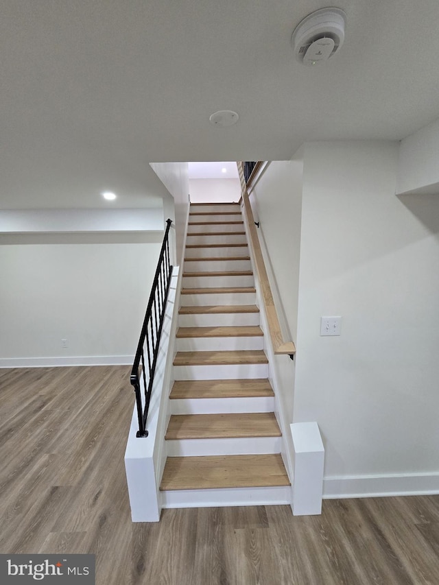 stairs with wood-type flooring