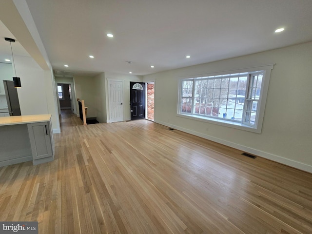 unfurnished living room with plenty of natural light and light wood-type flooring