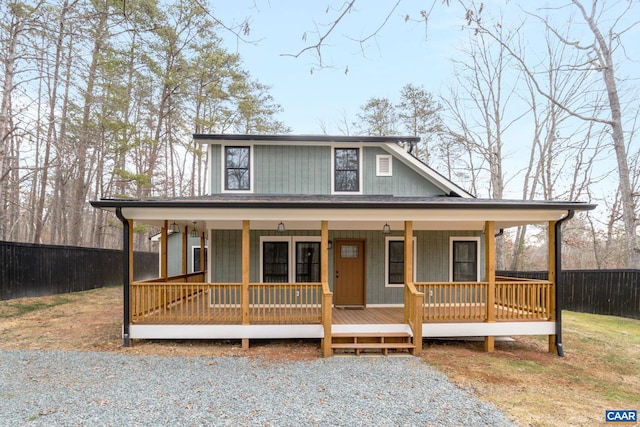 farmhouse inspired home featuring fence private yard and a porch