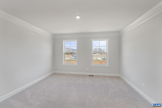 carpeted spare room featuring crown molding