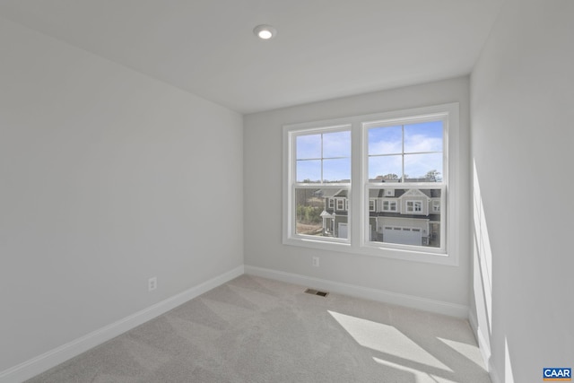 unfurnished room featuring light colored carpet