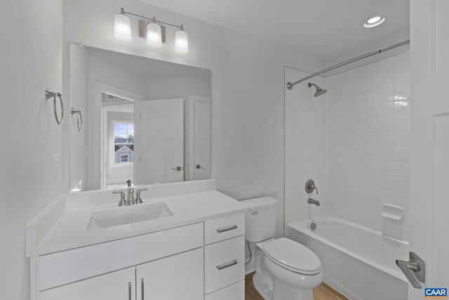 full bathroom with vanity, toilet, and tiled shower / bath combo