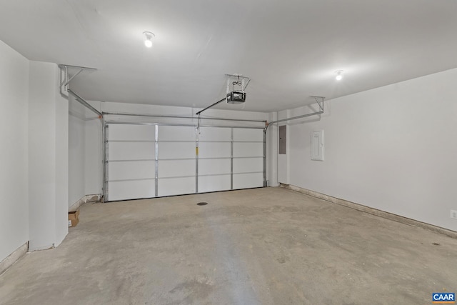 garage with a garage door opener and electric panel