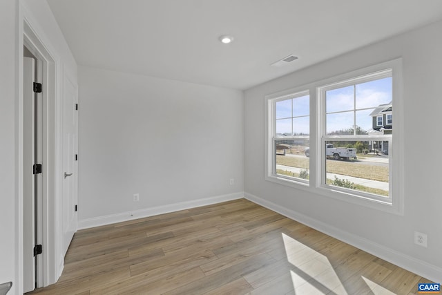 spare room with light wood-type flooring