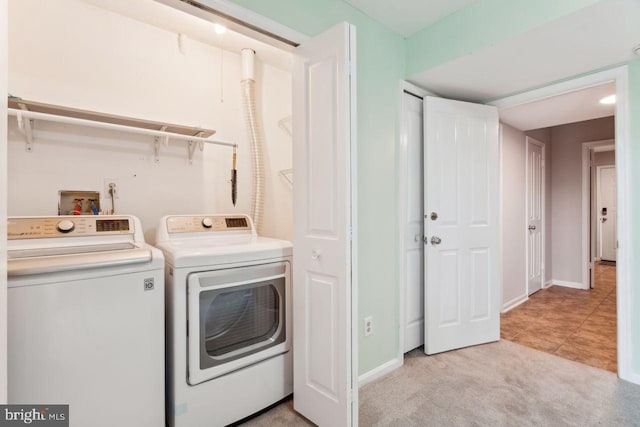 laundry area featuring independent washer and dryer and light colored carpet