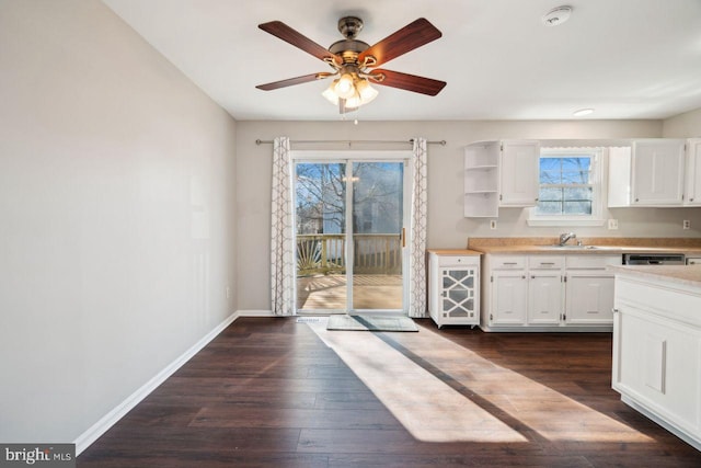 kitchen with dark wood-type flooring, sink, white cabinetry, dishwasher, and ceiling fan