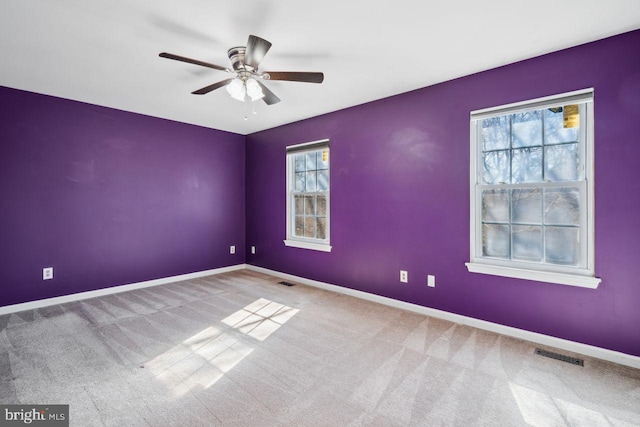 empty room featuring ceiling fan and carpet floors