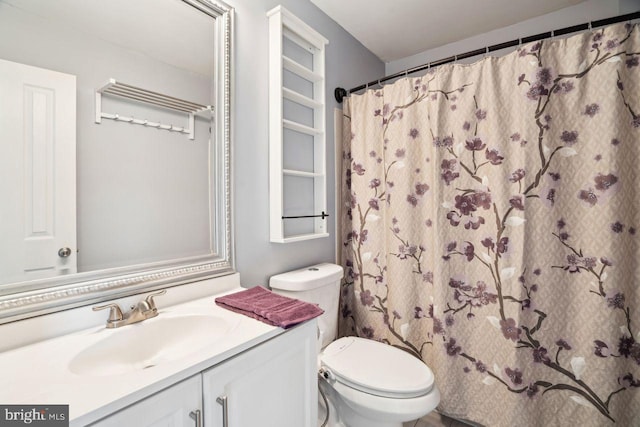 bathroom with vanity, walk in shower, and toilet