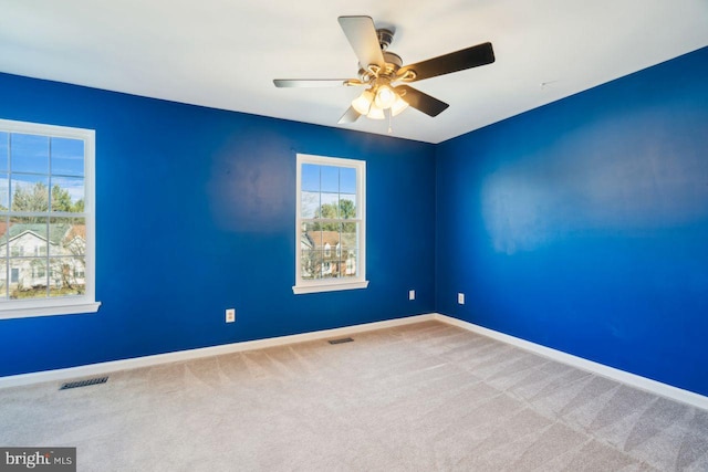 spare room featuring ceiling fan and carpet flooring