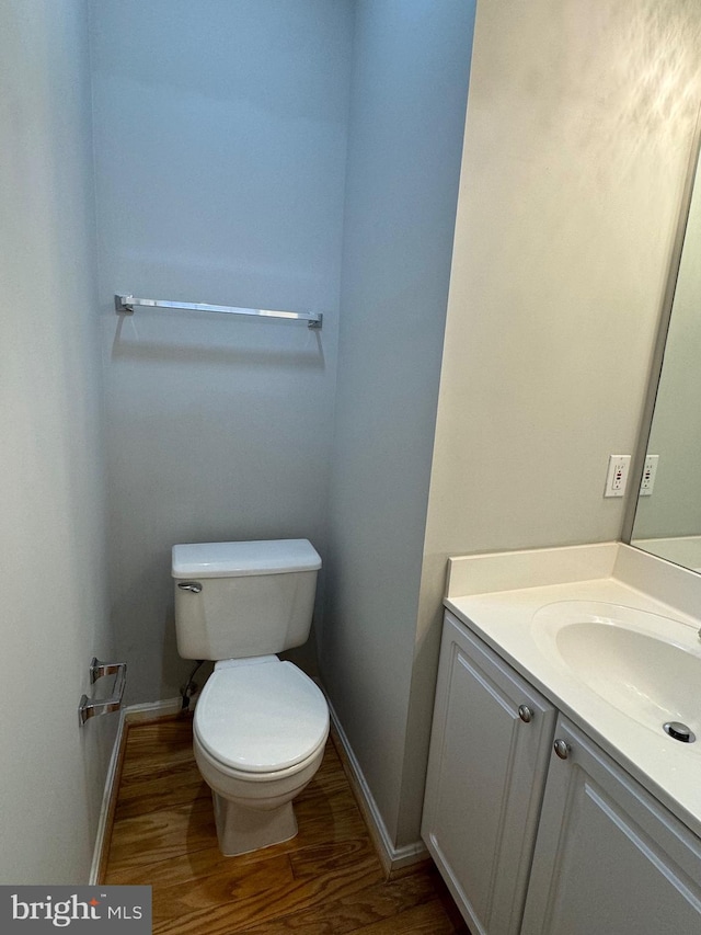 bathroom with vanity, hardwood / wood-style floors, and toilet