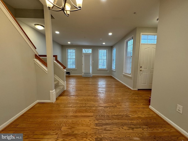 entrance foyer featuring an inviting chandelier and hardwood / wood-style floors