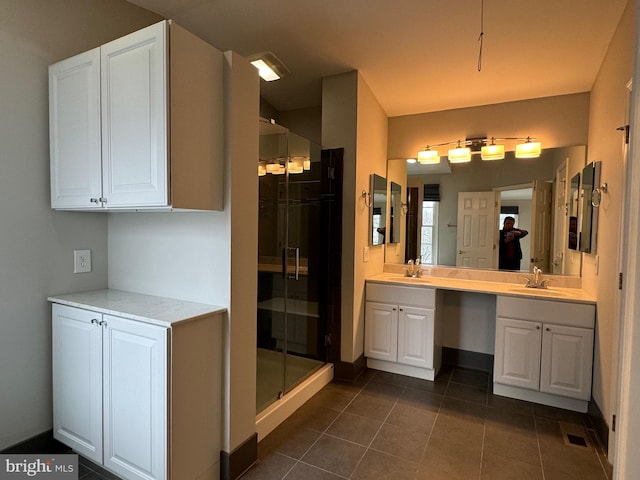 bathroom with vanity, a shower with shower door, and tile patterned flooring