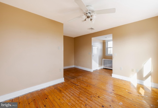 unfurnished room with hardwood / wood-style floors and ceiling fan