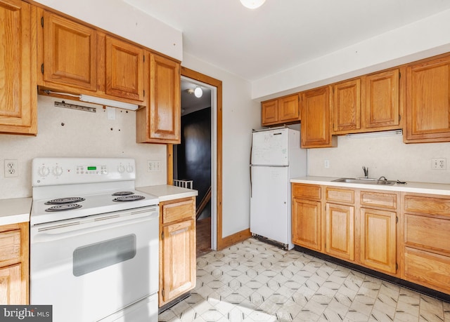 kitchen featuring sink and white appliances