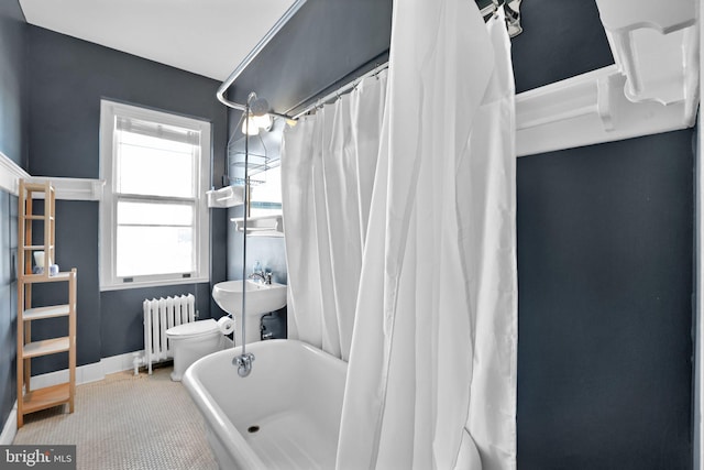 bathroom featuring toilet, radiator, and shower / bath combo