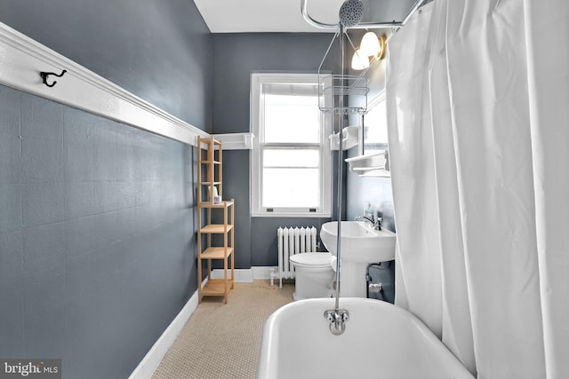 bathroom featuring shower / tub combo with curtain, radiator heating unit, and toilet