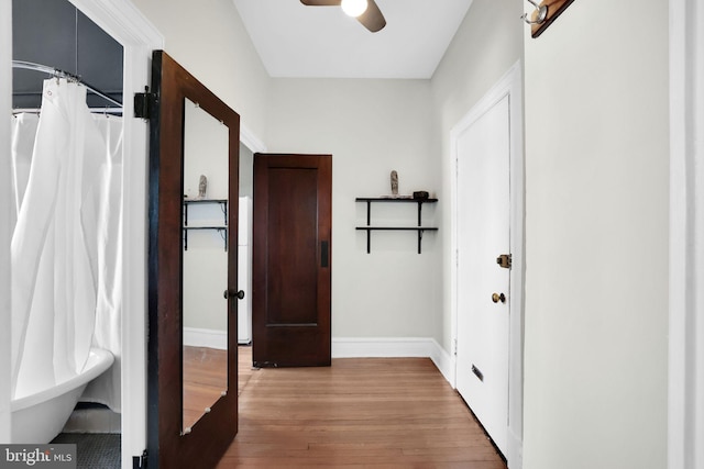 corridor with hardwood / wood-style flooring