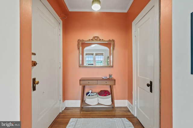 corridor featuring hardwood / wood-style flooring and ornamental molding