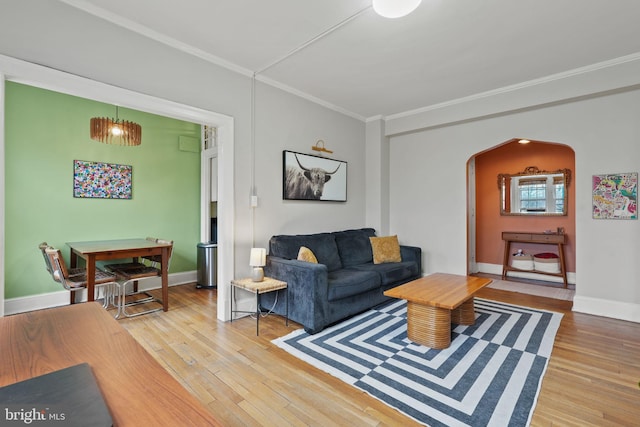 living room with ornamental molding and wood-type flooring