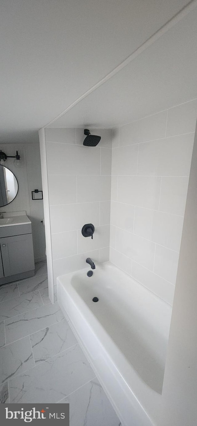 bathroom with vanity and tiled shower / bath combo