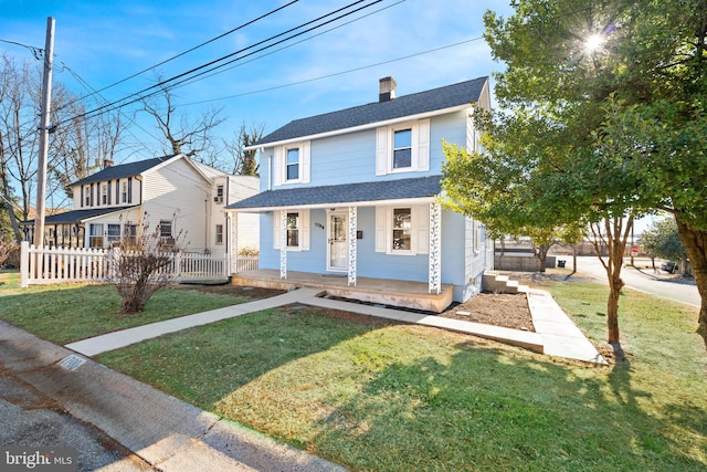 view of front of house with a front yard and a porch