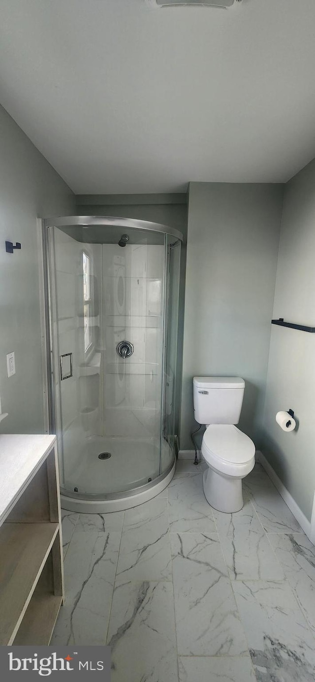 bathroom with walk in shower, vanity, and toilet