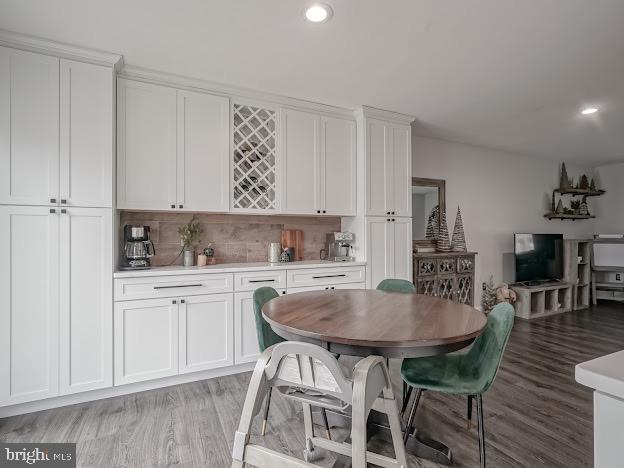 dining space featuring light hardwood / wood-style flooring and indoor bar