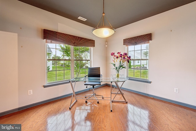 home office with hardwood / wood-style flooring