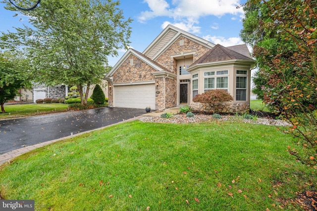 view of front of property featuring a garage and a front lawn