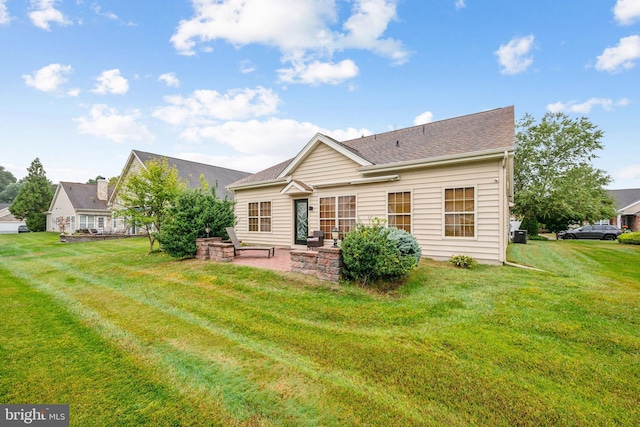 back of house featuring a yard and a patio area