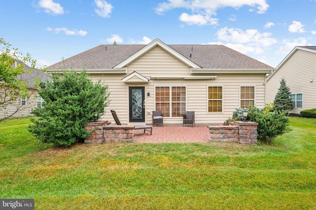 rear view of house with a lawn and a patio area