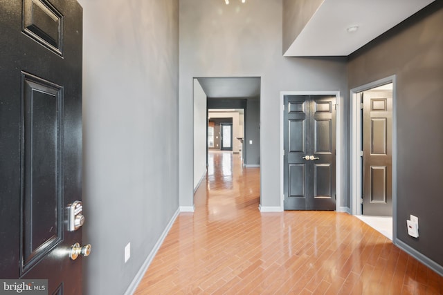 entryway with a high ceiling and light hardwood / wood-style floors