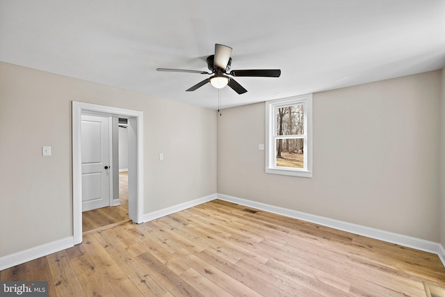 unfurnished room with ceiling fan and light wood-type flooring