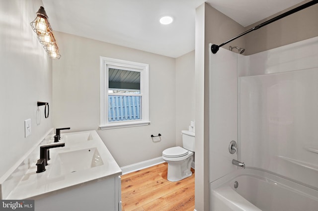 full bathroom with hardwood / wood-style flooring, shower / tub combination, vanity, and toilet