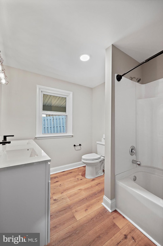 full bathroom with vanity, wood-type flooring,  shower combination, and toilet