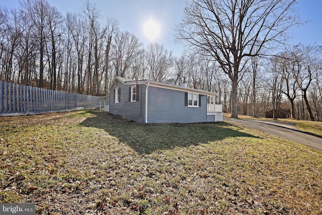 view of property exterior with a lawn