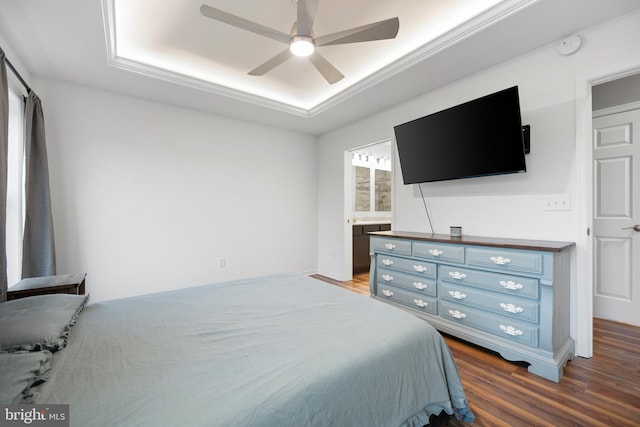 bedroom featuring ensuite bathroom, dark wood-type flooring, and ceiling fan