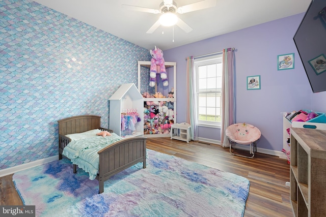 bedroom featuring hardwood / wood-style floors and ceiling fan