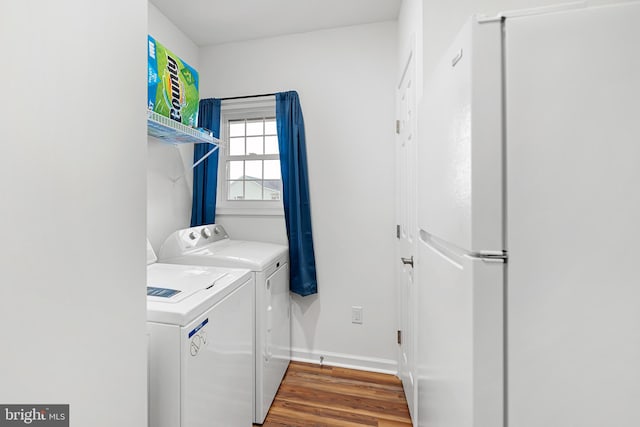 laundry area with washer and clothes dryer and hardwood / wood-style floors